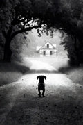 Silhouette of a dog standing on a road leading to a house in the distance, framed by trees.