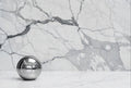 Silver sphere on a marble surface