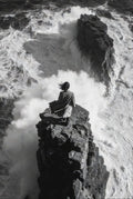 Person standing on a rocky outcrop with turbulent ocean below